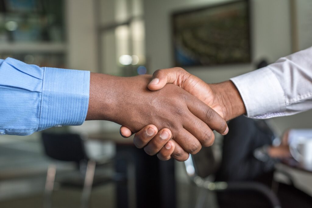 business men holding hands